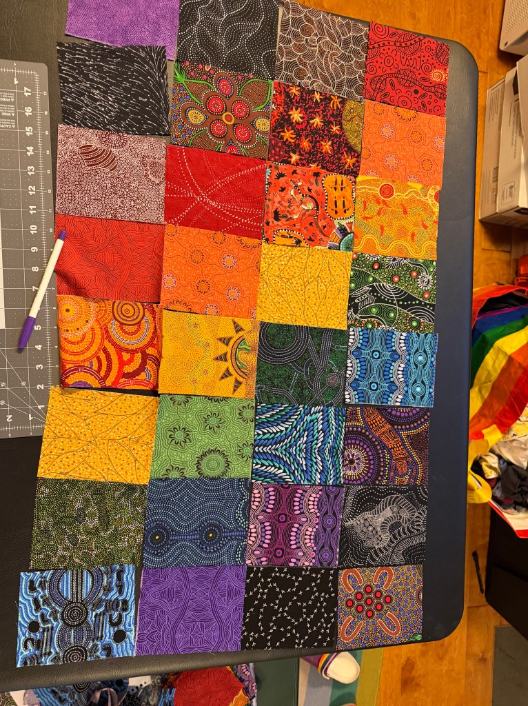 Colorful quilting fabrics, pieced together to make a curtain.